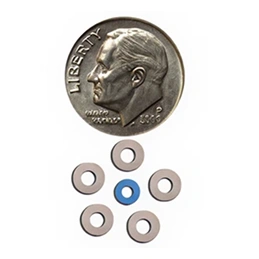 Orthodontic brackets displayed next to dime for size comparison scale reference.