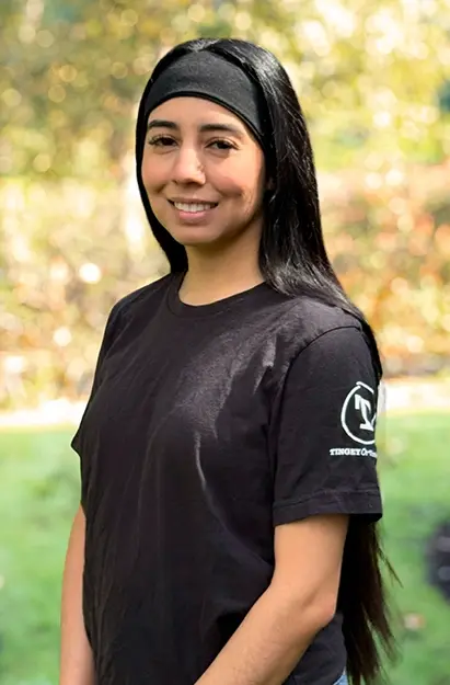 Ashley, dental team member at Issaquah dental practice, smiling outdoors.